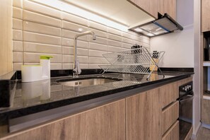 Experience a sleek, modern kitchen equipped with stylish finishes and essential amenities for your culinary adventures.