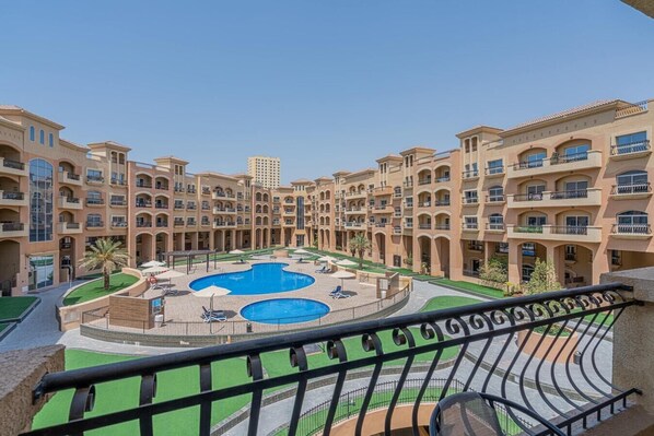 Balcony with outdoor furniture and pool view