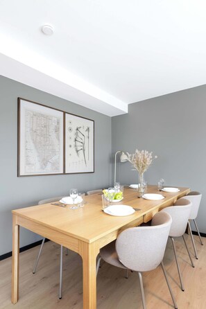 Light-filled space with a warm wooden table.