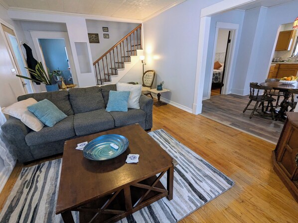 Living room with queen pull-out couch bed, fitted with 2" memory foam topper.
