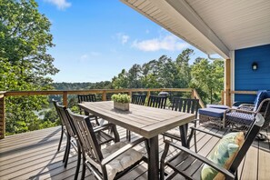 Upstairs deck with outdoor dining, cozy accommodations, and lake views!