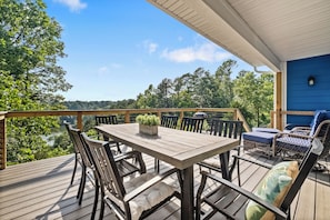 Upstairs deck with outdoor dining, cozy accommodations, and lake views!