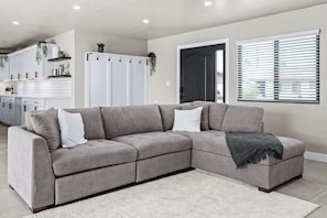Relax on a plush sectional in this bright, open-concept living room.