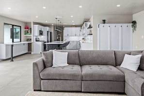 Large sectional, dining table, and sliding doors to paradise