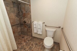 Modern bathroom with a walk-in shower and fresh towels, offering a relaxing experience.