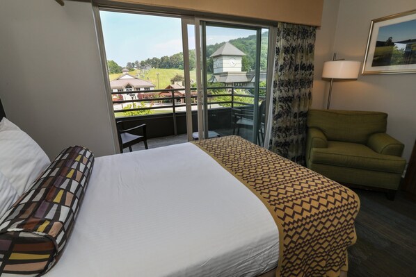Bright and airy room with a comfortable bed and direct access to a private balcony with scenic views.