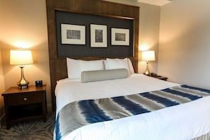 Elegant room featuring a plush bed, stylish décor, and bedside lighting for a cozy ambiance.