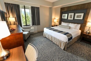 Elegant and inviting guest room with plush bedding and warm décor.