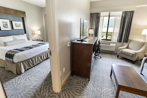 Spacious guest room with a comfortable bed and a cozy seating area for relaxation.