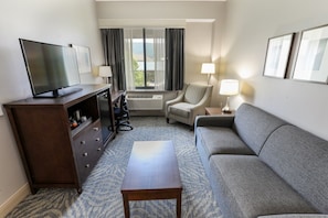 Well-appointed suite with ample seating and a separate living area, perfect for unwinding.