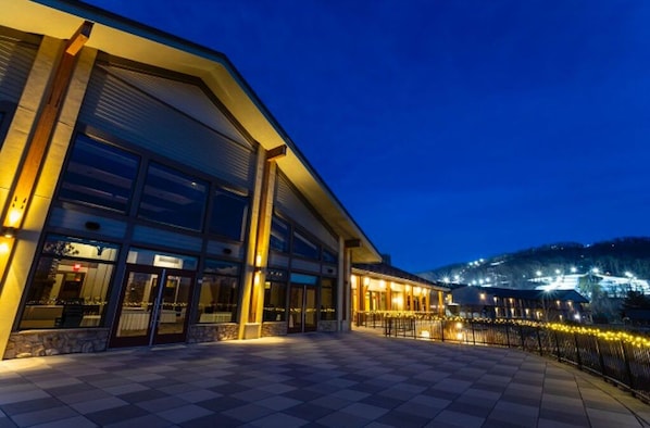 The lodge shines under the night sky, offering a perfect blend of elegance and comfort.