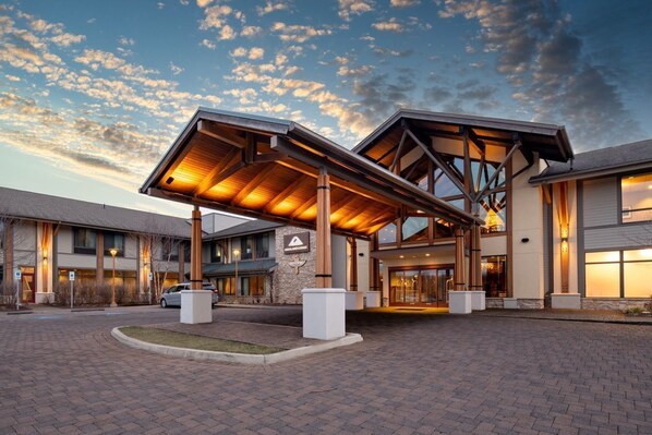 A warm welcome awaits beneath the beautifully lit entrance of this mountain retreat.