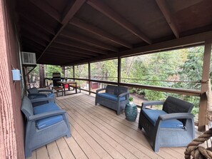 Covered Deck with seating area, dining area and BBQ