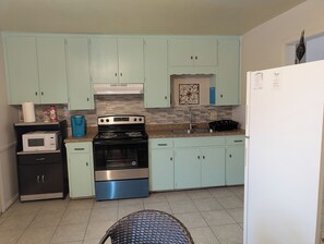 Fully stocked kitchen, cooking utensils, silverware pots pans  coffee 