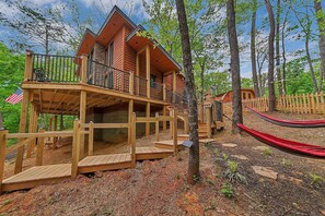 Stairs from parking area to the deck/entry. Neighbor cabin behind.