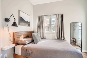 Our queen sized bed and blackout curtains will make you want to stay here all day