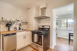 Range hood complemented the modern stainless steel appliances and the historic charm of this unit