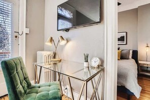 The smart TV above the desk can be used as an external monitor to simplify working from home