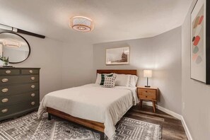 A comfortable queen sized bed in a spacious room