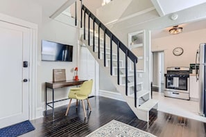 Beautiful staircase to loft with an office area situated underneath it and a Smart TV
