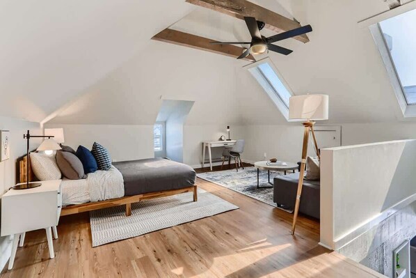 Wooden beams and the vaulted ceiling add to the historic charm of this unit