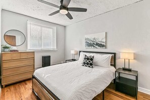 Master bedroom has restored chest of drawers and queen sized bed