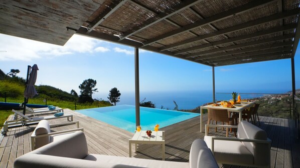 Villa Amêndoa by LovelyStay is a luxury retreat in Calheta, Madeira. Enjoy breathtaking ocean views, an infinity pool, sun loungers, and elegant outdoor spaces perfect for al fresco dining and relaxation #pool #calheta # airbnb #deck