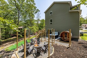Fire pit, hot tub, putting green and barrel sauna – our Poconos home has everything you need for a memorable outdoor experience.