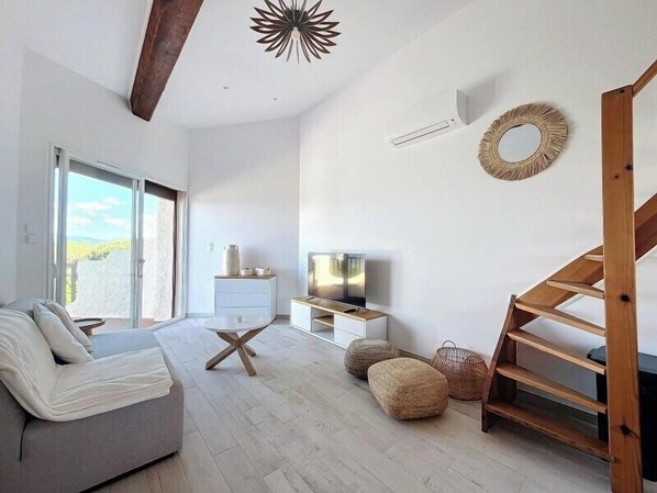 Lounge area and terrace access with connected TV