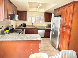 Full kitchen with is close, but not too close, to action in the other rooms.