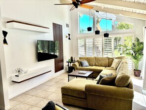 Family room with 65" TV and comfortable couch.