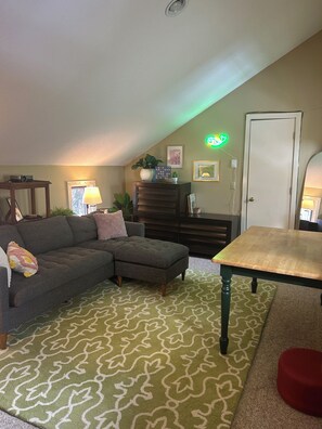 Loft, with a projector, workspace, and drawers of games, books, & puzzles