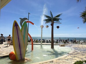 Vibrant splash area with waterfall, fountains, sculptures & ocean views