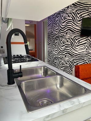 Kitchen Area with Cooker, fridge, drinks fridge and seating area