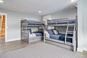 The perfect bunk room for your crew! With plenty of beds, a cozy crib, and a comfy couch, everyone has a spot to relax. Ideal for families or groups, this space is made for fun and comfort after a day of adventure!