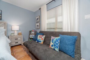 Relax and unwind on our stylish couch, perfect for cozy evenings or accommodating extra guests. This inviting space features soft cushions and lovely decor, making it a delightful spot to enjoy your stay. 