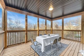 Self-enclosed large Muskoka room, with barbecue grill and mosquito net to keep out any bugs.