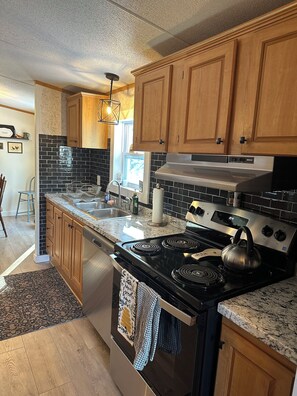 Full kitchen with new appliances including dishwasher