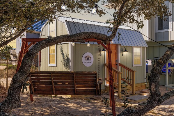 Sea Shed exterior with Swing hanging from our Live Oak Tree 