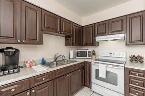 This kitchen includes all needed equipment for cooking, including spice racks!