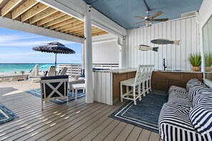 Huge 1st Floor Patio features 6 lounge chairs, a dining table for 8, large gas grill, bar seating, mini-fridge, firepit, and sink - Beachfront Grilling!