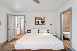 Bedroom 2: King bed, upper floor, en-suite bathroom, decorative chair, standing mirror
