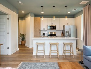 Living room with a sleep sofa and a fully equipped kitchen.