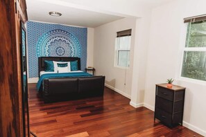 Spacious bedroom with a cozy queen bed and stylish decor.