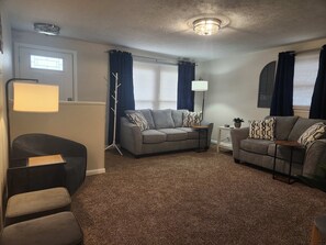 Living room w/ 55" SmartTV and fireplace