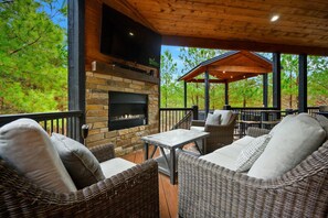 Lounge in comfort by the cozy fireplace and smart TV on the lower deck