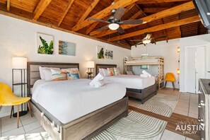 Two steps to paradise: Relax on cloud-like linens, then admire the tropical charm above.