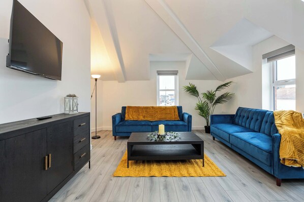 Interior designed living room with comfy sofas and smart TV.  N.B. One of the sofas has been replaced with a new sofa bed