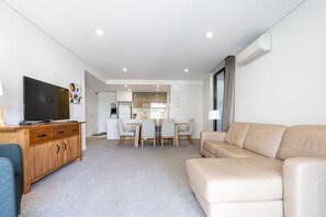 Relax in our comfy lounge room, featuring plush seating and a cosy atmosphere. This inviting space is perfect for unwinding after a long day.