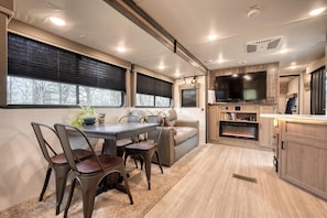 Dine, relax, and unwind fireside in this bright and inviting living space.